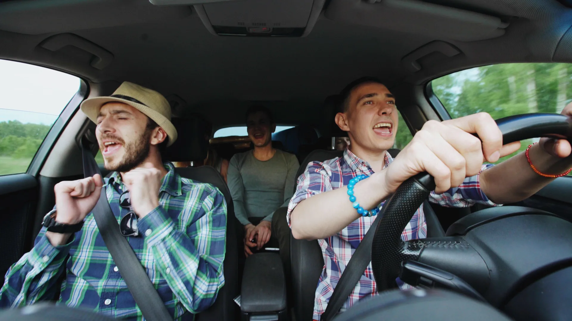 Friends singing karaoke in a car